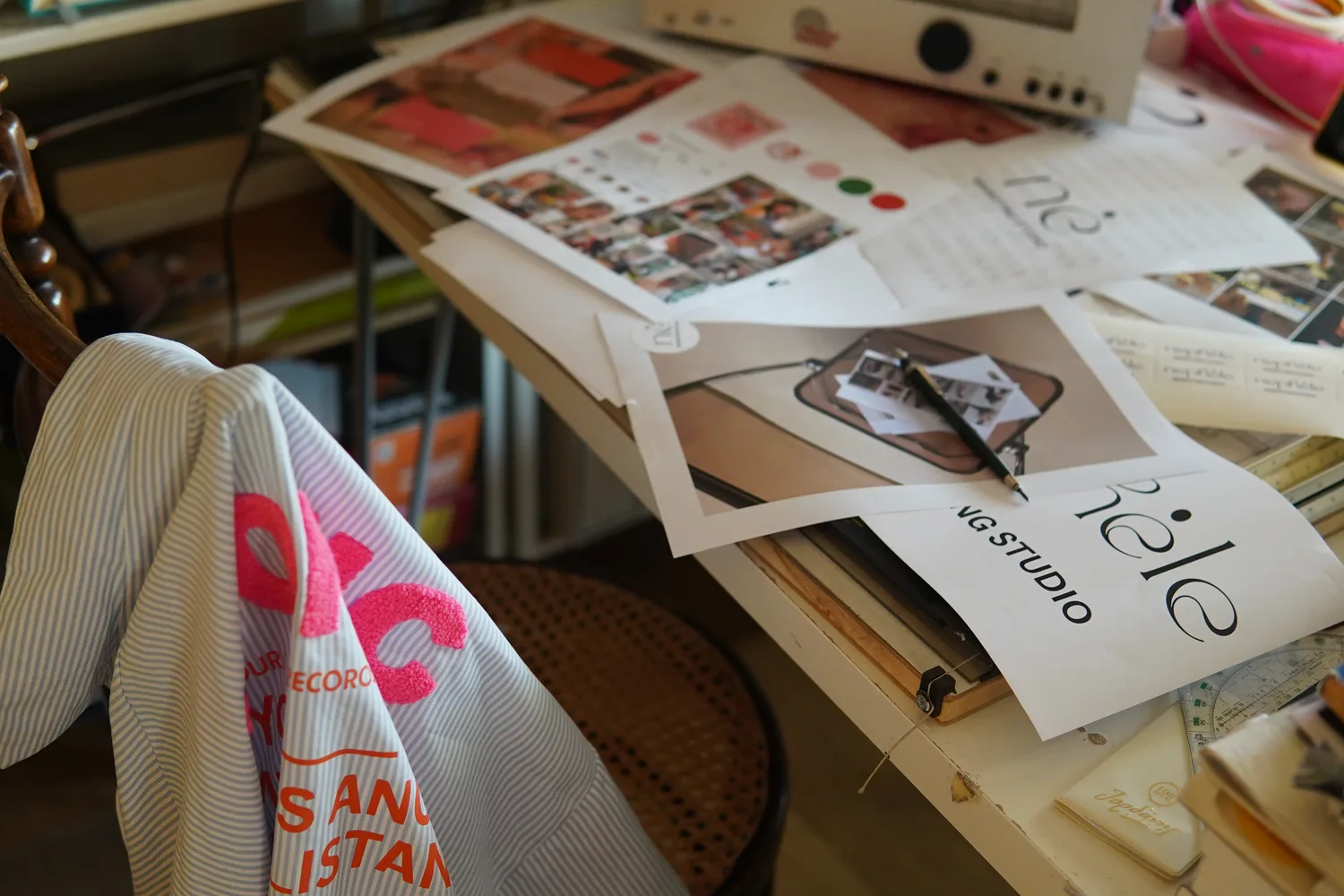 Brand moodboards and studio prints on the desk